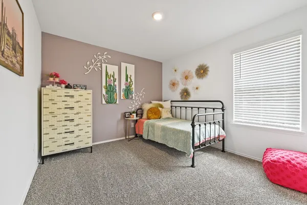 a bedroom with furniture and a window