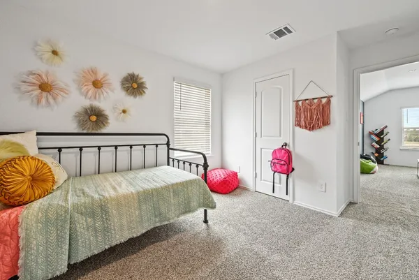 a bedroom with bed and window