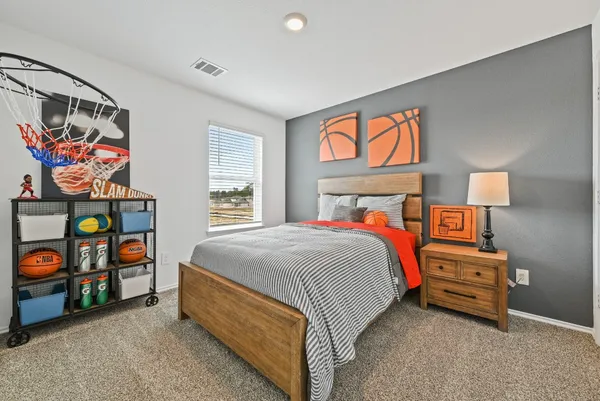 a bed sitting in a bedroom next to a window