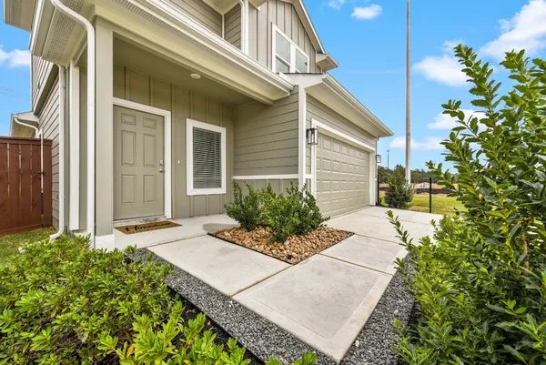 a view of a house with potted plants