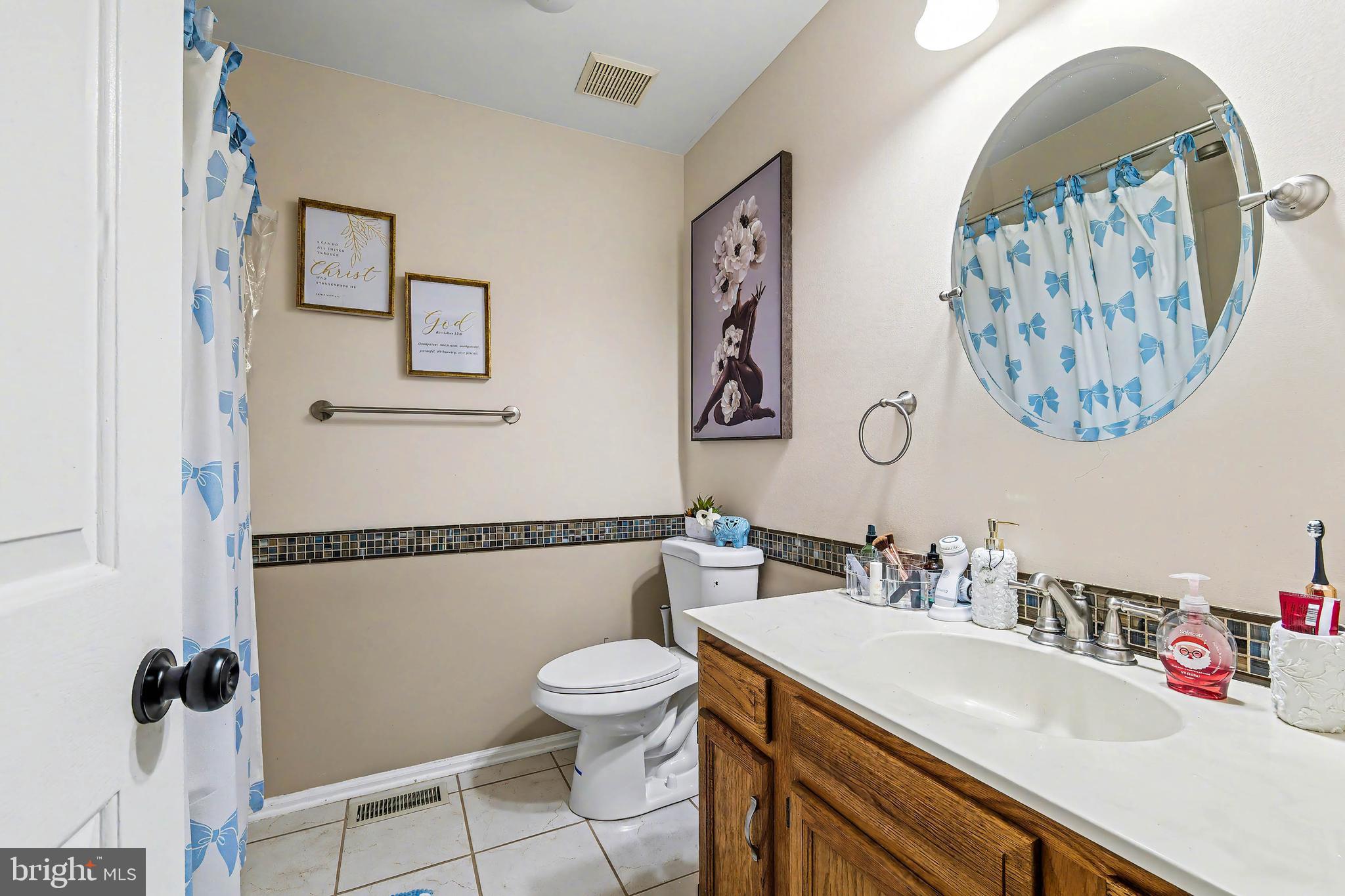 775 Quail Place Deptford, NJ 08096 - Photo 15 of 17 a bathroom with a sink mirror vanity and toilet