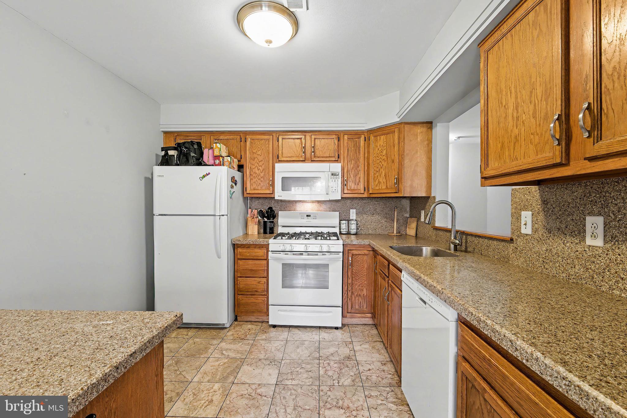 775 Quail Place Deptford, NJ 08096 - Photo 8 of 17 a kitchen with a refrigerator sink and cabinets