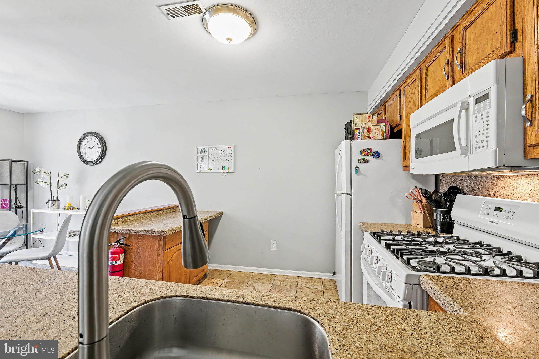 775 Quail Place Deptford, NJ 08096 - Photo 9 of 17 a kitchen with stainless steel appliances granite countertop a stove a sink and a refrigerator