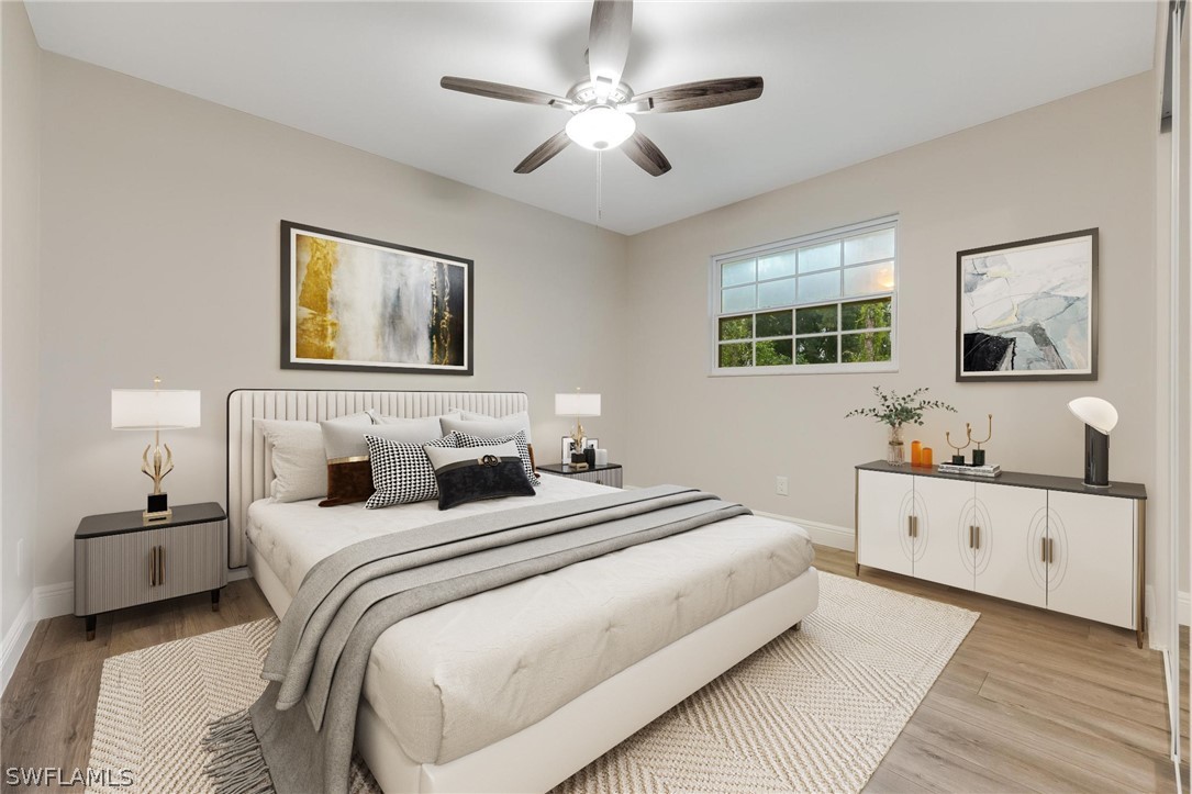 18804 Matanzas Road Fort Myers, FL 33967 - Photo 16 of 19 a bedroom with bed and a chandelier