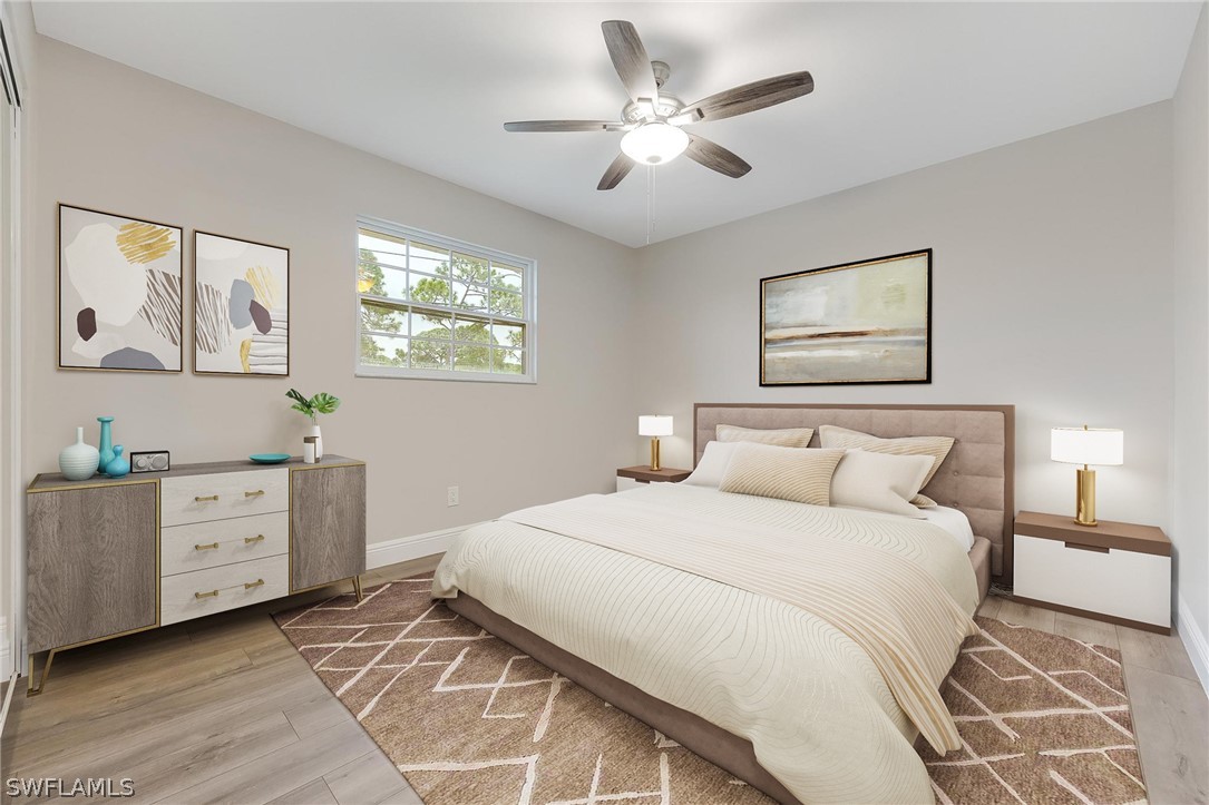 18804 Matanzas Road Fort Myers, FL 33967 - Photo 17 of 19 a bedroom with a bed and a chandelier