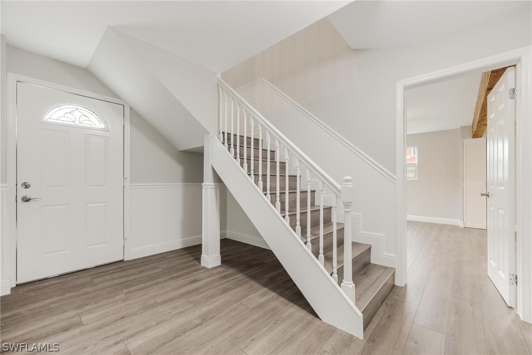 18804 Matanzas Road Fort Myers, FL 33967 - Photo 6 of 19 a view of a hallway with wooden floor and entryway