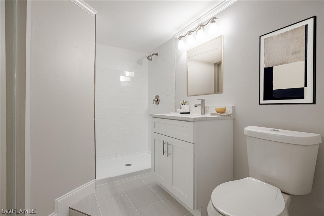 18804 Matanzas Road Fort Myers, FL 33967 - Photo 9 of 19 a bathroom with a toilet sink vanity and mirror
