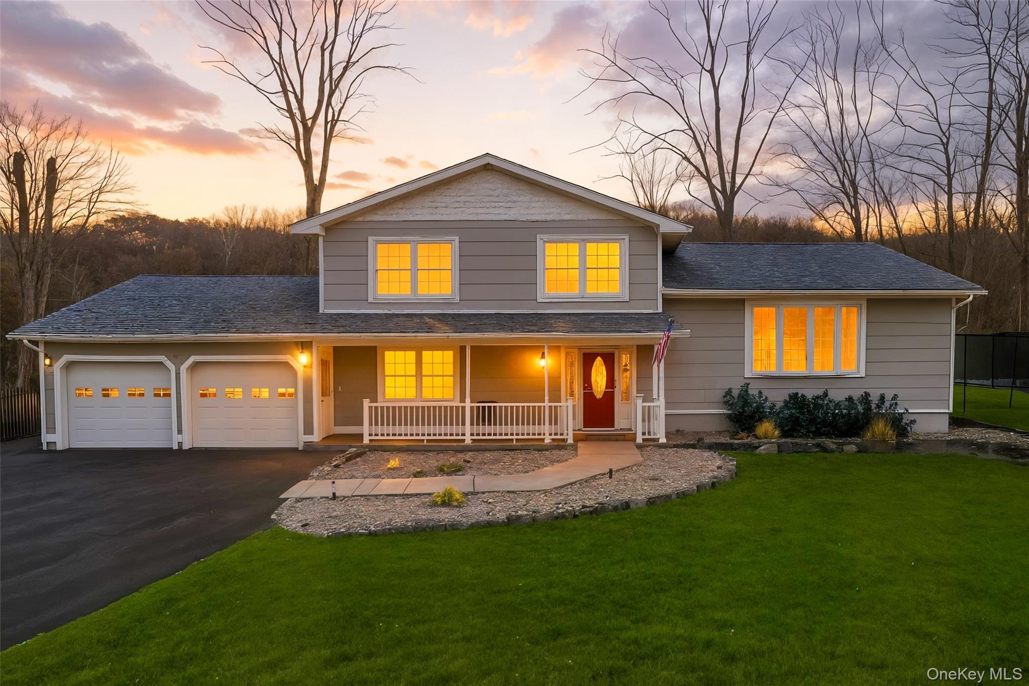 a view of a house with a yard and tree s