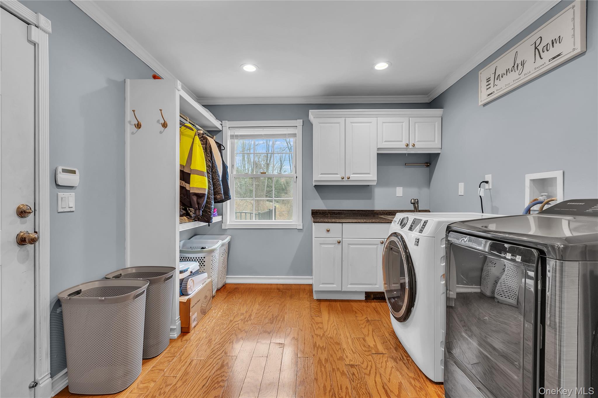 297 Church Road Putnam Valley, NY 10579 - Photo 13 of 42 Laundry room with crown molding, light wood finished floors, independent washer and dryer, cabinet space, and recessed lighting