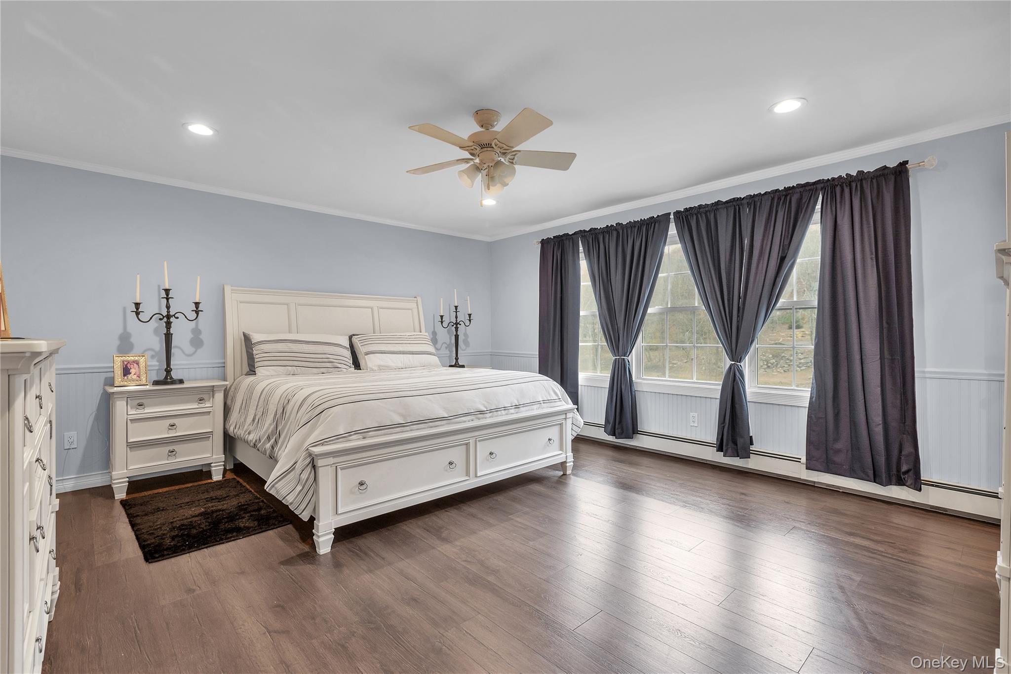 297 Church Road Putnam Valley, NY 10579 - Photo 19 of 42 a bedroom with a large bed and a chandelier