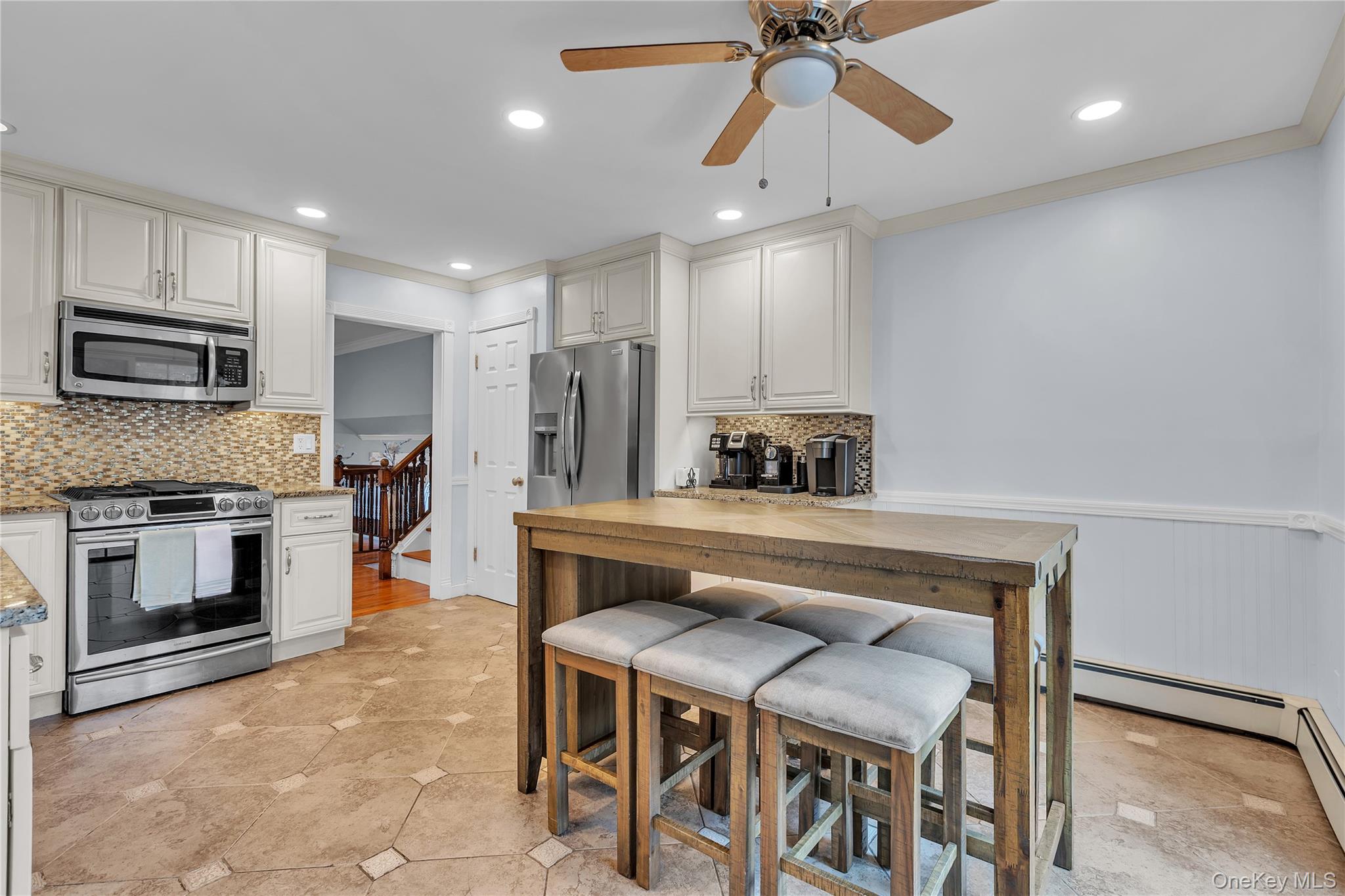 297 Church Road Putnam Valley, NY 10579 - Photo 7 of 42 Kitchen with backsplash, appliances with stainless steel finishes, ornamental molding, recessed lighting, and a ceiling fan