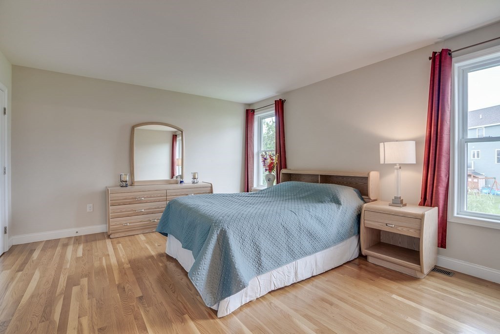68 Diamondback Avenue Nashua, NH 03062 - Photo 12 of 22 a bedroom with a large bed and a large window