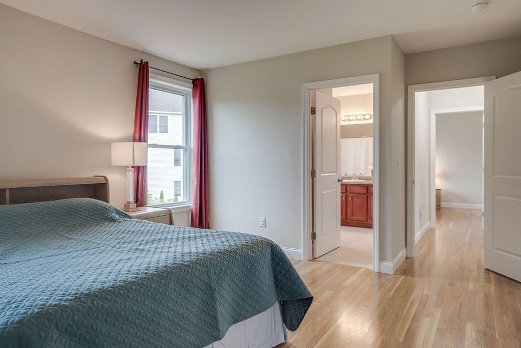 68 Diamondback Avenue Nashua, NH 03062 - Photo 13 of 22 a bedroom with a bed and a mirror