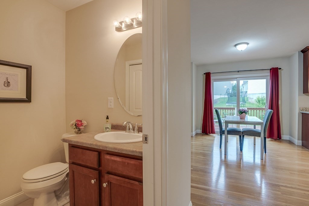 68 Diamondback Avenue Nashua, NH 03062 - Photo 16 of 22 a bathroom with a sink a toilet a mirror and a window