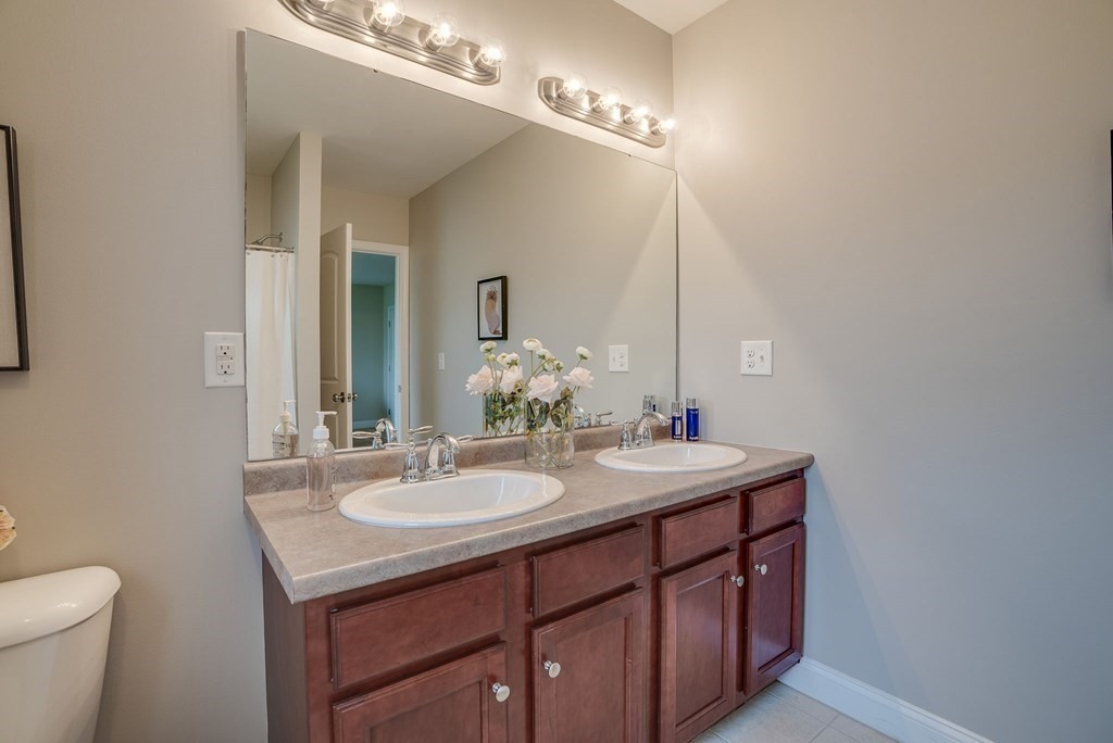 68 Diamondback Avenue Nashua, NH 03062 - Photo 18 of 22 a bathroom with a sink and a mirror