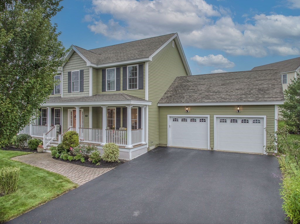 68 Diamondback Avenue Nashua, NH 03062 - Photo 2 of 22 a front view of a house with a garden