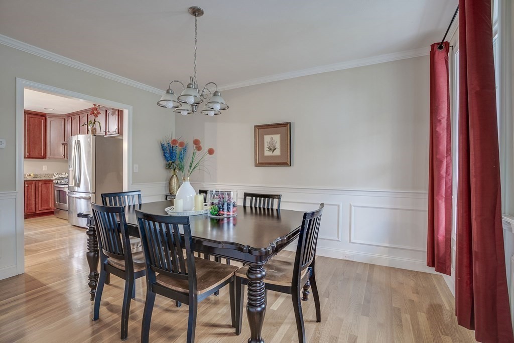 68 Diamondback Avenue Nashua, NH 03062 - Photo 7 of 22 a view of a dining room with furniture and chandelier