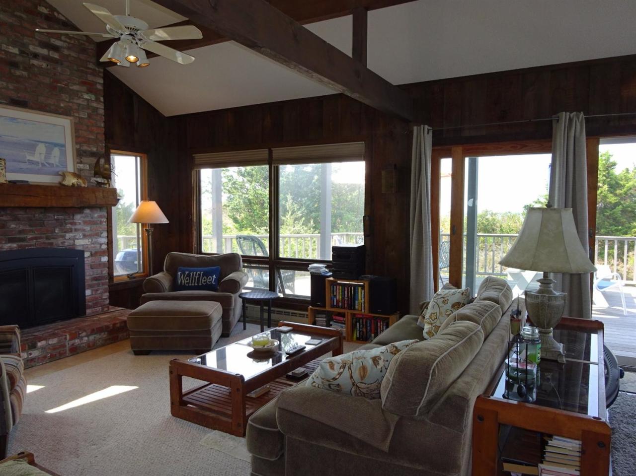 51 9th Street Wellfleet, MA 02667 - Photo 12 of 35 a living room with furniture a fireplace and a large window