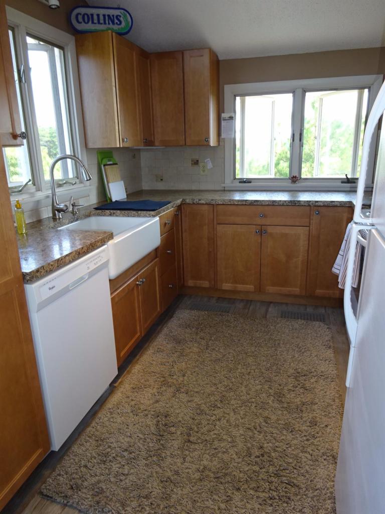 51 9th Street Wellfleet, MA 02667 - Photo 16 of 35 a kitchen with a sink window and cabinets