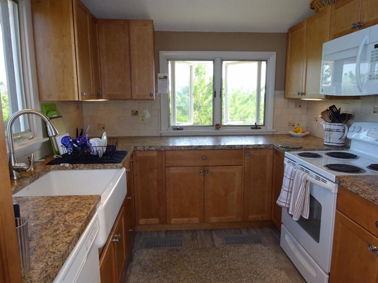 51 9th Street Wellfleet, MA 02667 - Photo 17 of 35 a kitchen with a sink stove and cabinets