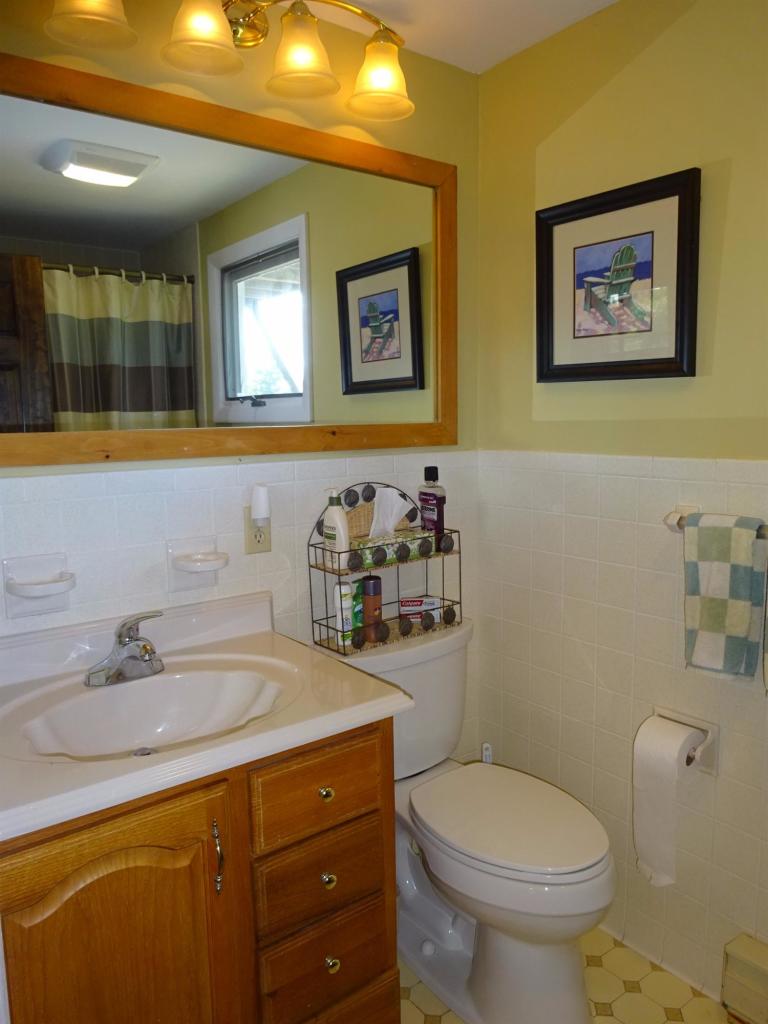 51 9th Street Wellfleet, MA 02667 - Photo 29 of 35 a bathroom with a toilet sink and mirror
