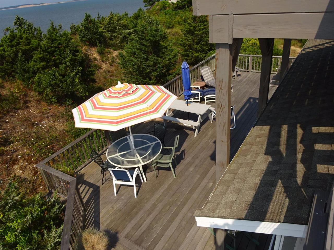 51 9th Street Wellfleet, MA 02667 - Photo 9 of 35 a balcony with table and chairs