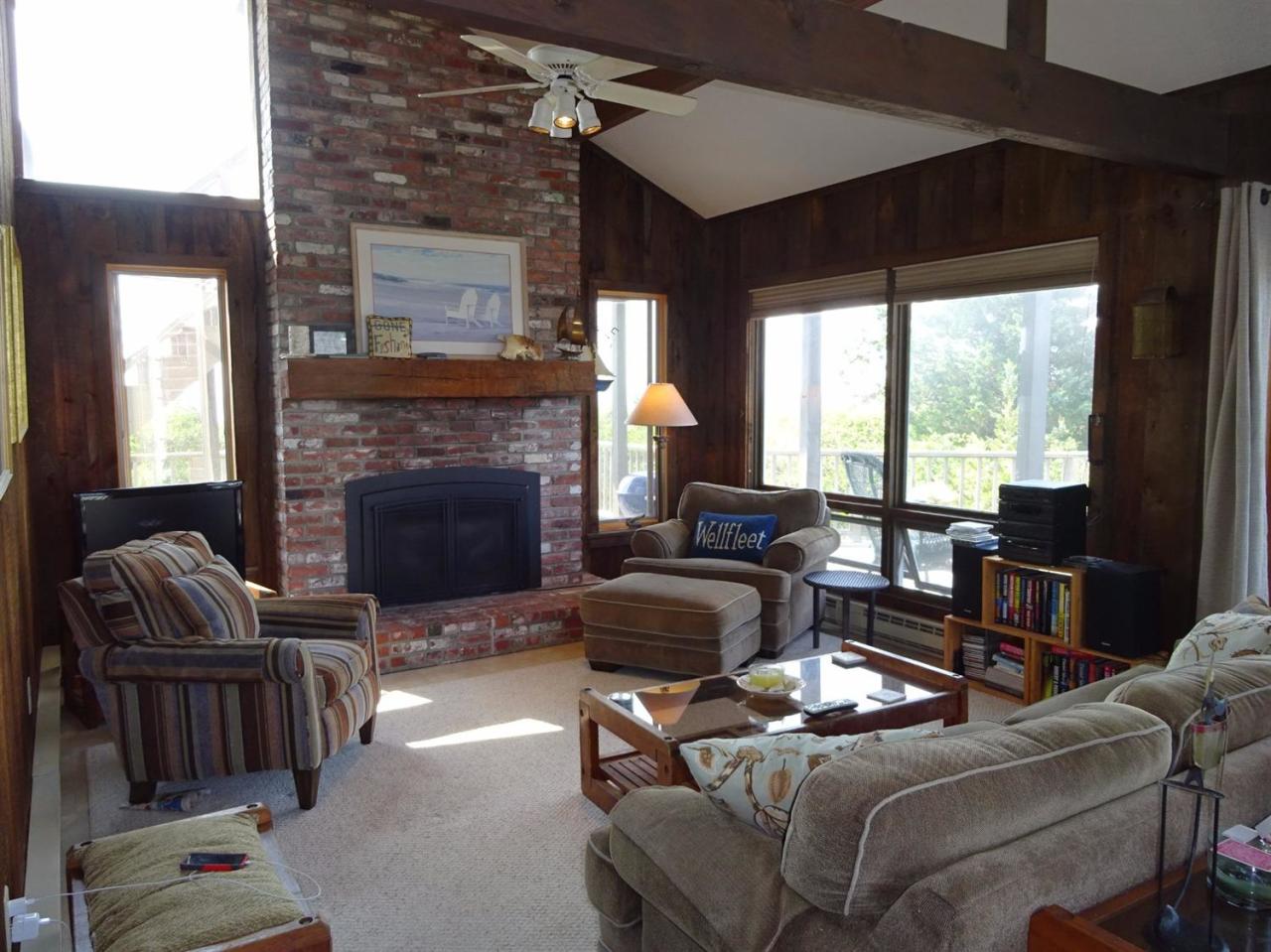51 9th Street Wellfleet, MA 02667 - Photo 10 of 35 a living room with furniture a fireplace and a large window