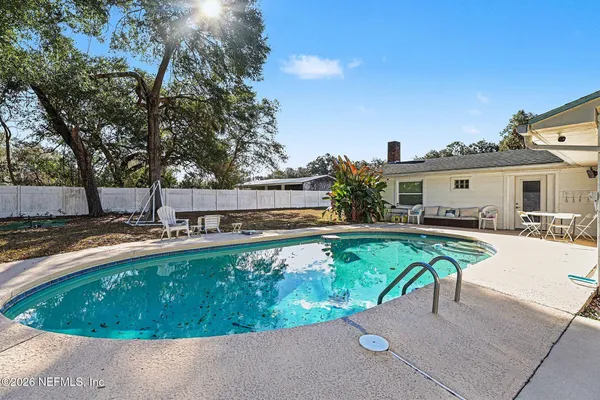 a view of a swimming pool with a patio