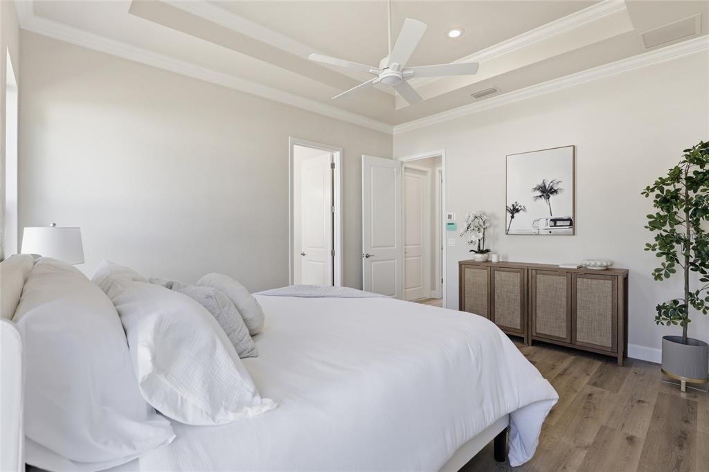 13425 Southwest 9th Road Newberry, FL 32669 - Photo 20 of 46 a spacious bedroom with a bed and a chandelier