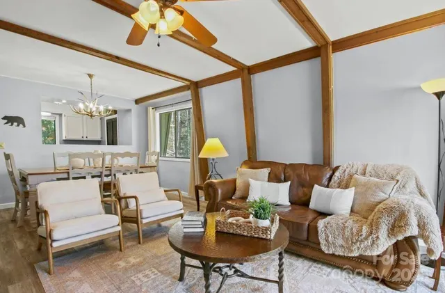 a living room with furniture and a chandelier