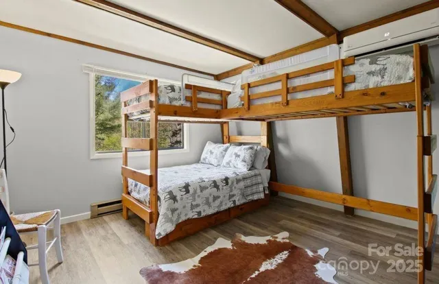 a bed sitting in a bedroom next to a window