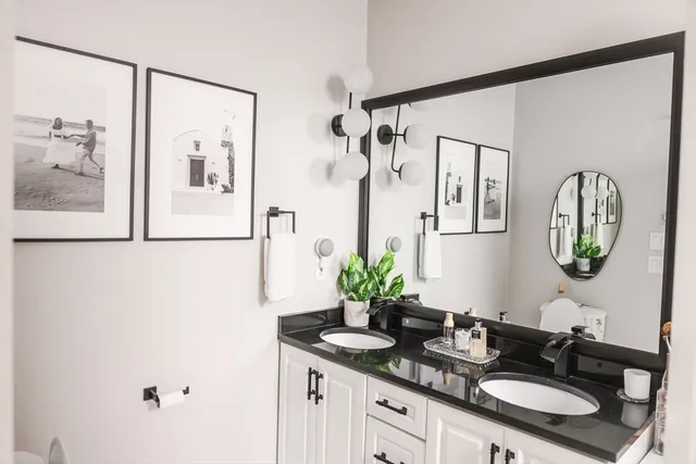 a bathroom with a granite countertop sink mirror and vanity