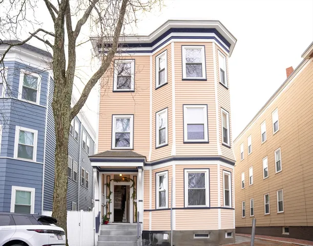 a front view of a residential apartment building with a yard