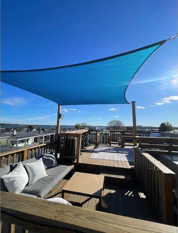 a view of a balcony with furniture and a table