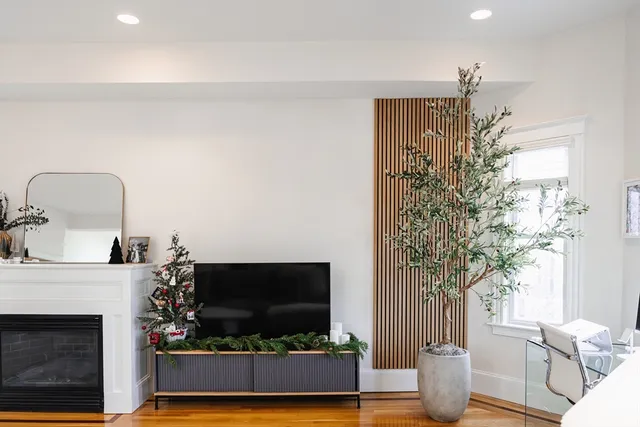 a living room with furniture a flat screen tv and a fireplace