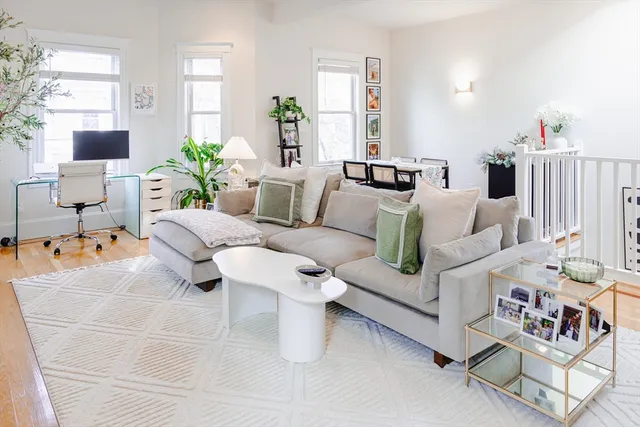 a living room with furniture and flowers