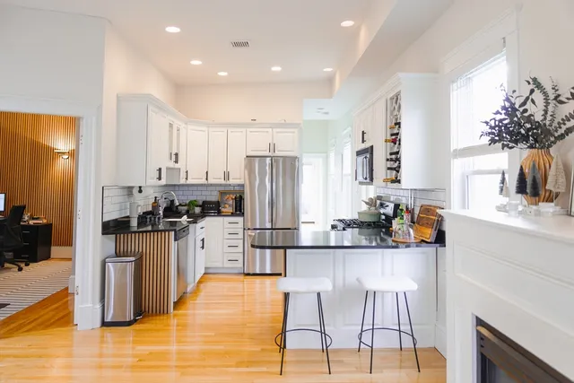 a kitchen with stainless steel appliances kitchen island granite countertop a sink and cabinets