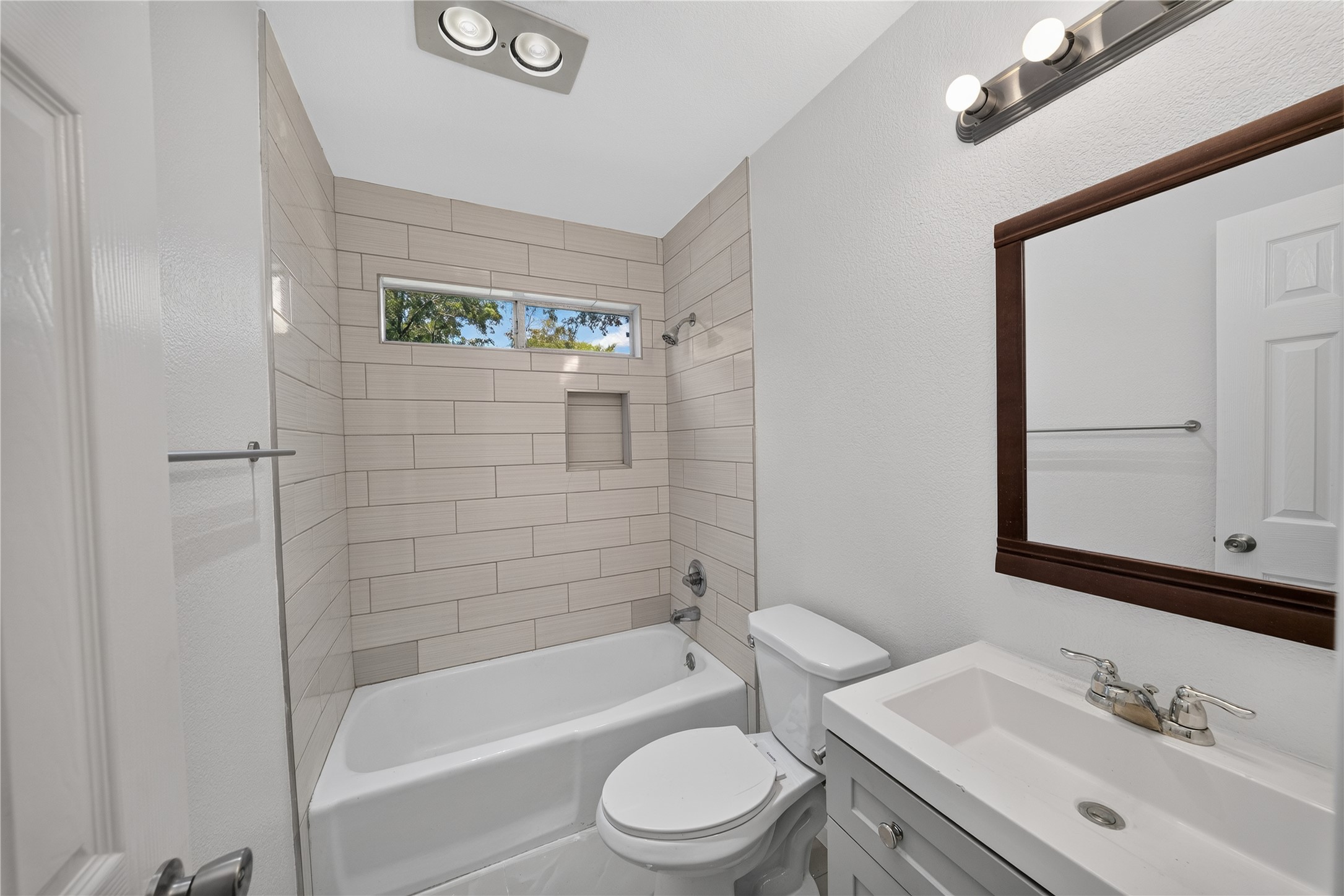 339 Fantail Loop, Unit B Austin, TX 78734 - Photo 19 of 21 a bathroom with a bathtub shower sink vanity mirror and toilet