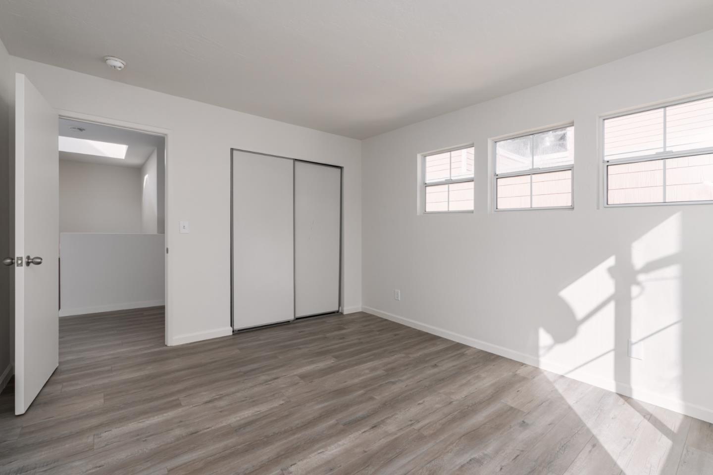 435 Norfolk Drive Pacifica, CA 94044 - Photo 16 of 28 wooden floor in an empty room with a window
