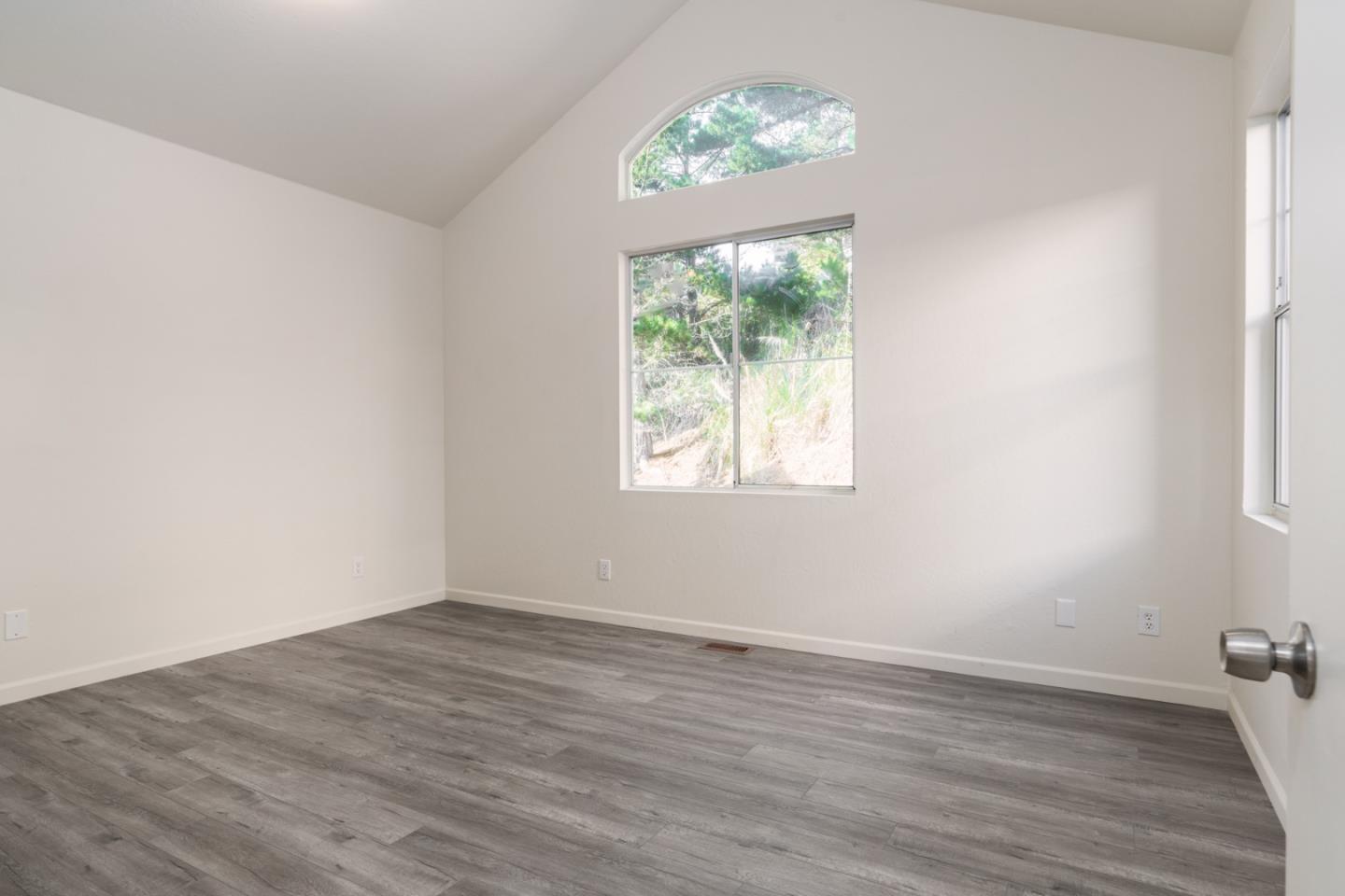 435 Norfolk Drive Pacifica, CA 94044 - Photo 7 of 28 an empty room with wooden floor and a window