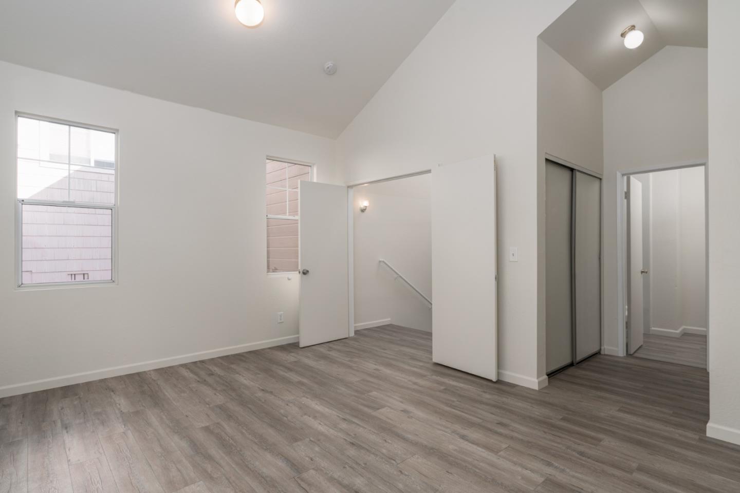 435 Norfolk Drive Pacifica, CA 94044 - Photo 8 of 28 an empty room with wooden floor and windows