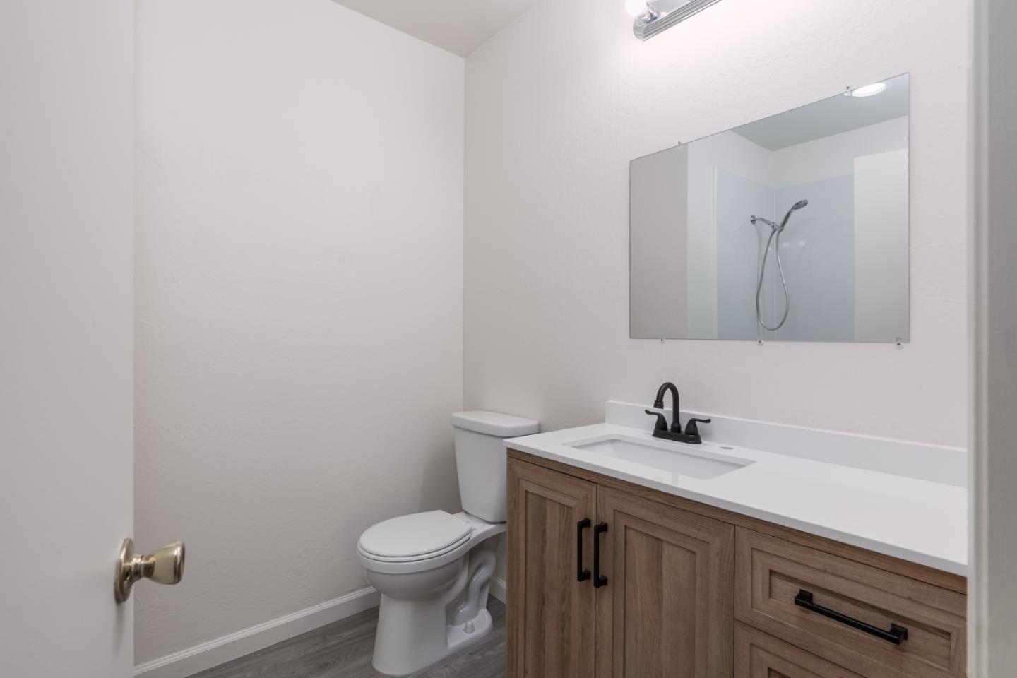 435 Norfolk Drive Pacifica, CA 94044 - Photo 10 of 28 a bathroom with a toilet a sink and mirror