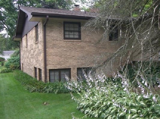 810 Roxbury Road Rockford, IL 61107 - Photo 3 of 13 a front view of a house with a garden