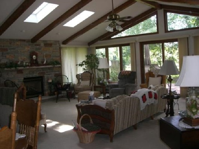 810 Roxbury Road Rockford, IL 61107 - Photo 7 of 13 a living room with furniture fireplace and a large window