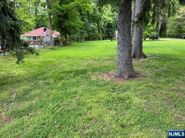 19 Crescent Road Wayne, NJ 07470 - Photo 25 of 26 a front view of a house with a yard and large trees