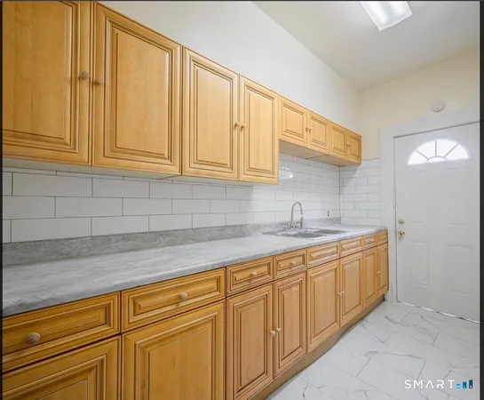 a kitchen with stainless steel appliances granite countertop a sink and cabinets