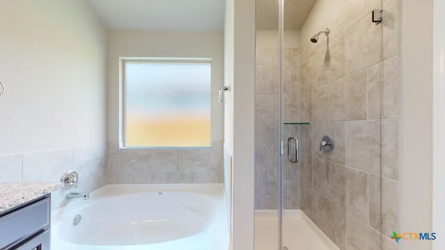 a bathroom with a bathtub and shower