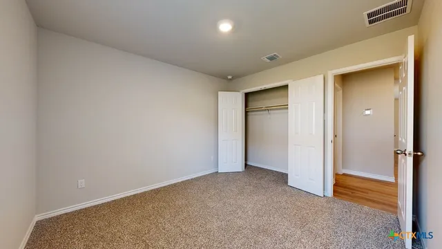 an empty room with closet area
