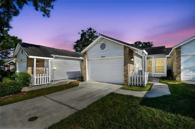 a front view of a house with a yard and outdoor seating
