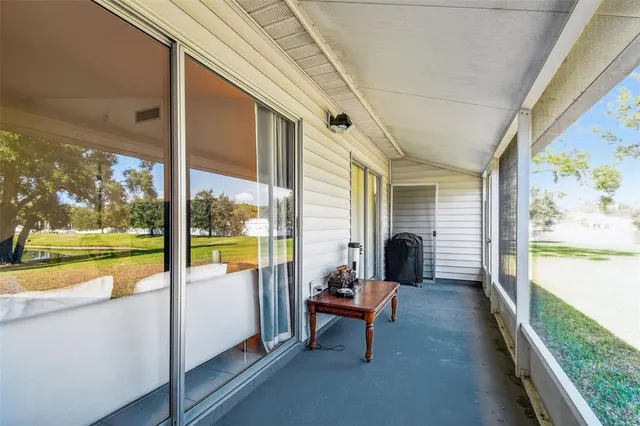 a living room with furniture and floor to ceiling windows
